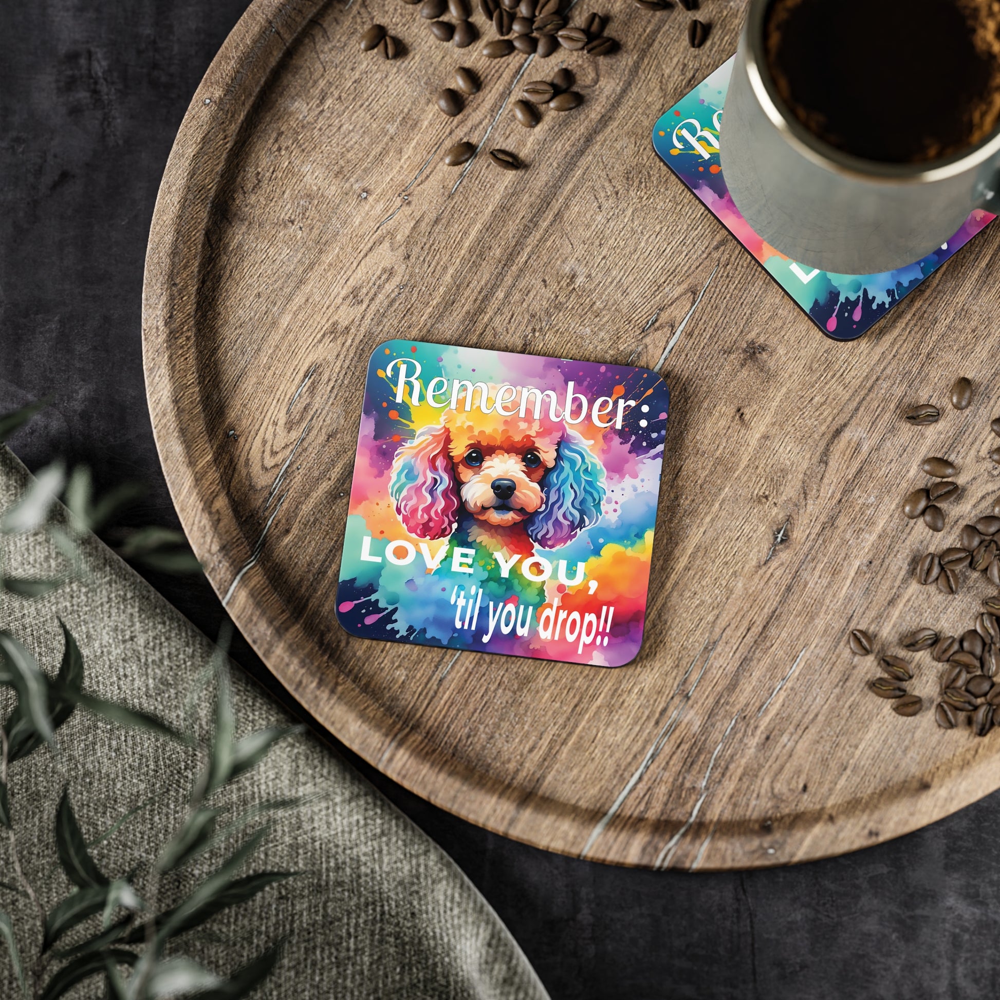 Coaster with a dog illustration and words, "LOVE YOU, 'til you drop." on a wooden tray with coffee.