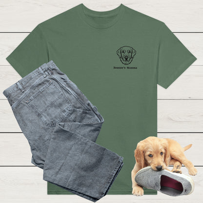 Military Green t-shirt with custom embroidery of a dog and personalised text along with wardrobe suggestion of blue jeans on a wooden surface, with a puppy playing with a shoe in the background.