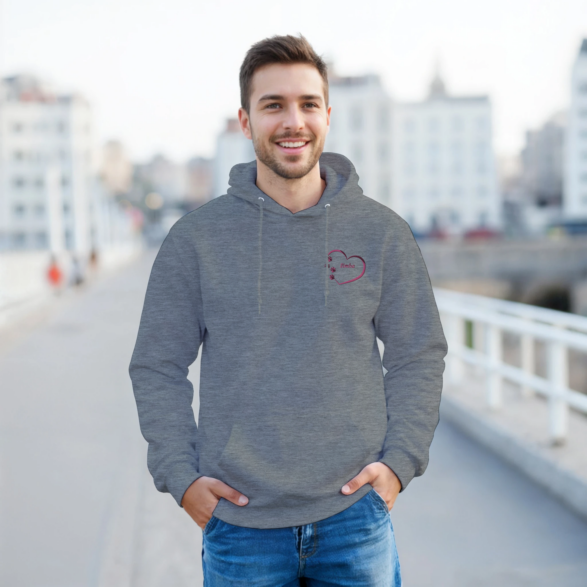 Ash Grey Custom Embroidery, Heart Personalized with Pet's Name on a Pullover Hoodie Sweatshirt on man walking across a bridge