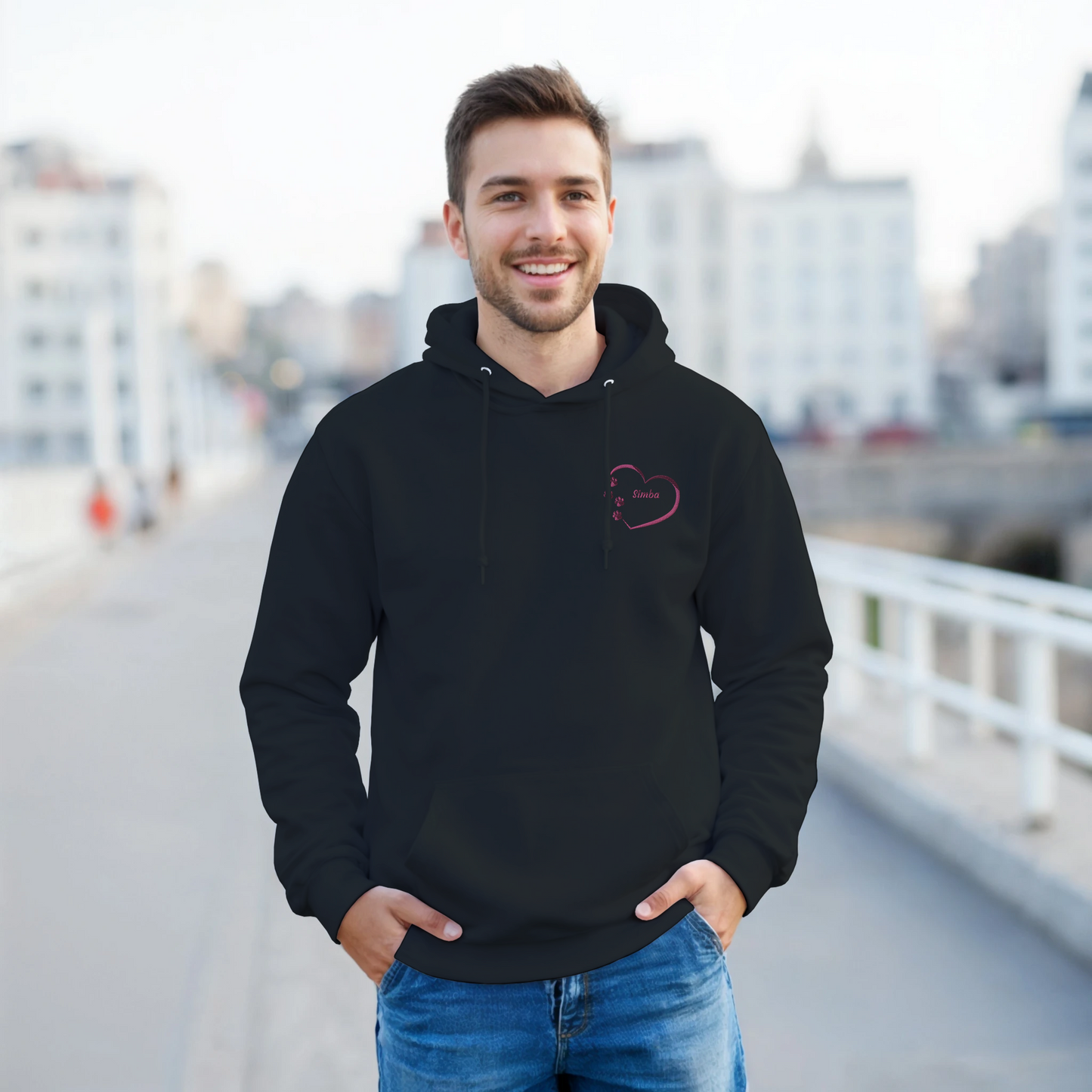 Black Custom Embroidery, Heart Personalized with Pet's Name on a Pullover Hoodie Sweatshirt on man walking on a bridge