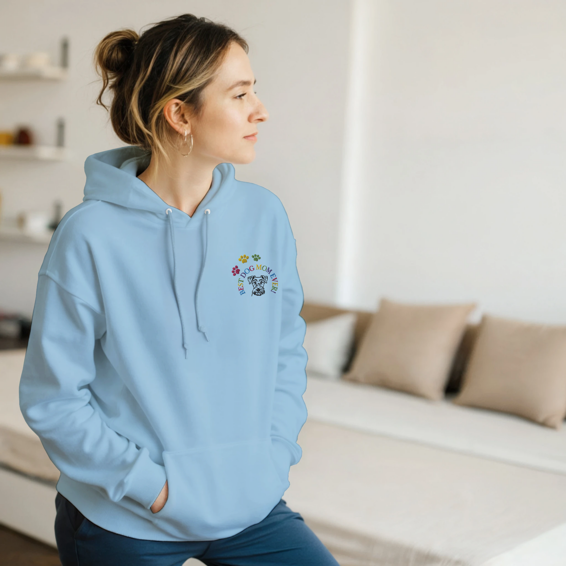 Custom Embroidered Classic Pullover Hoodie | Best Dog Mom Ever! Woman in a  light blue hoodie standing in a bedroom.