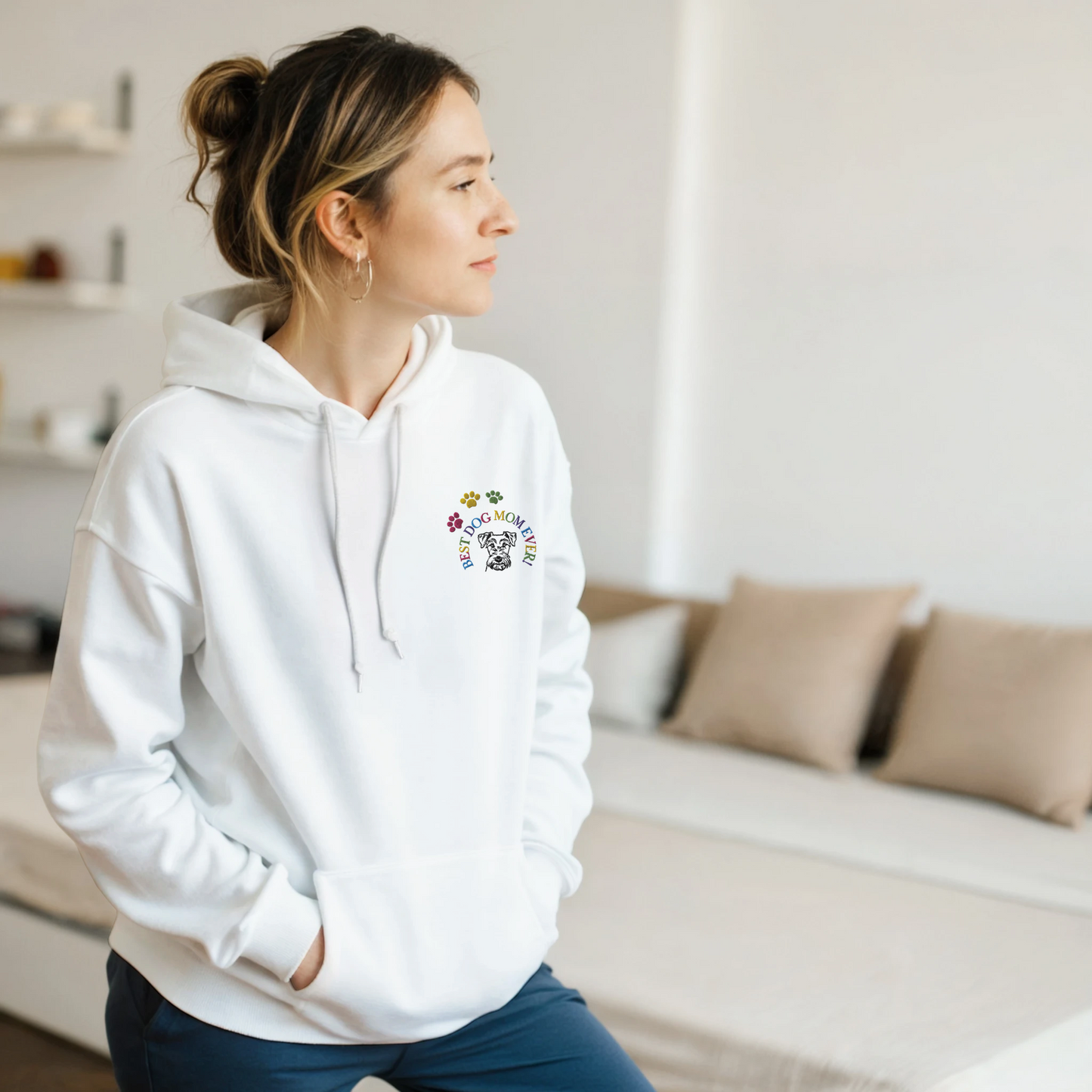 Custom Embroidered Classic Pullover Hoodie | Best Dog Mom Ever! Woman in a white hoodie standing in a bedroom.