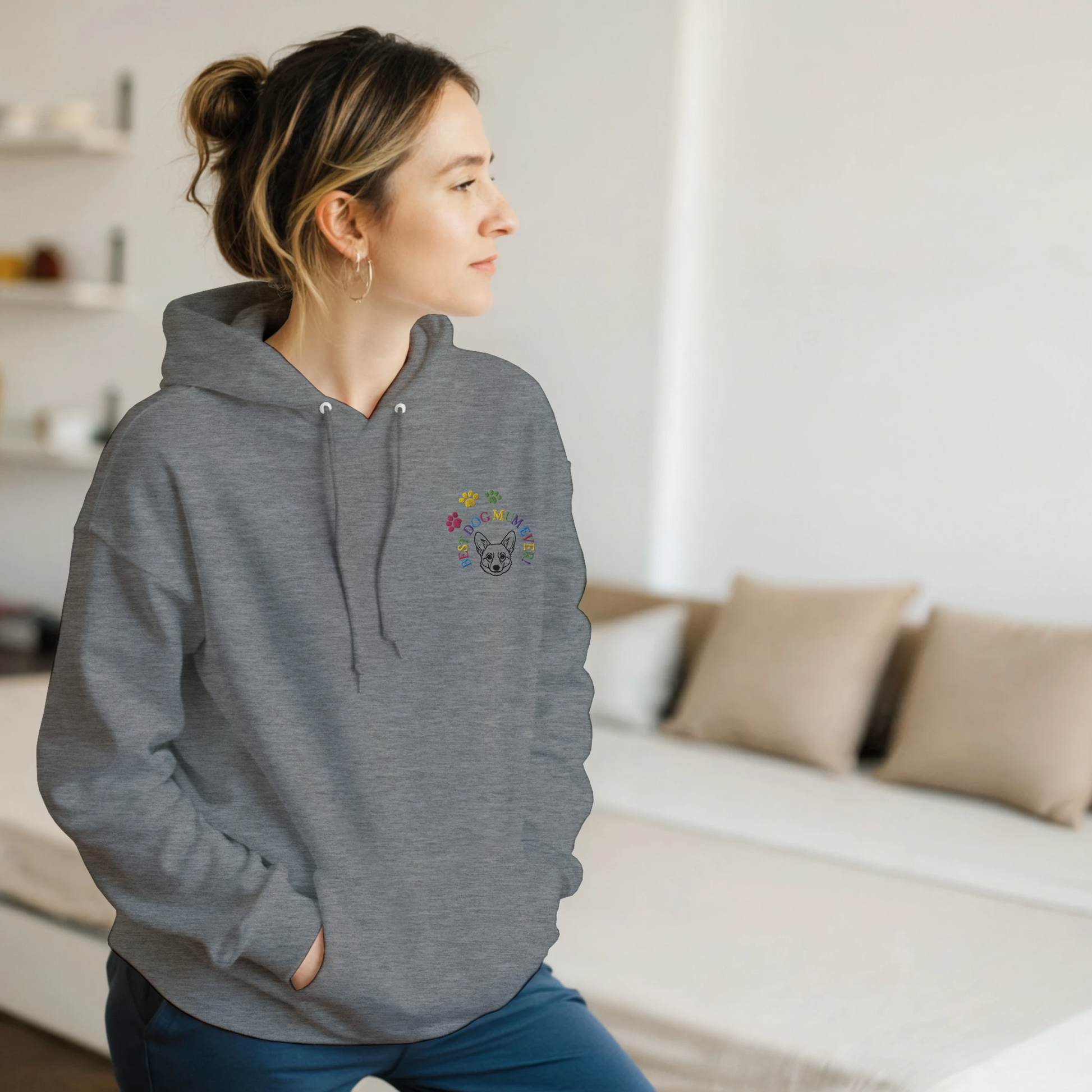 Custom Embroidered Classic Pullover Hoodie | Best Dog Mum Ever! Woman in a grey hoodie standing in a bedroom.