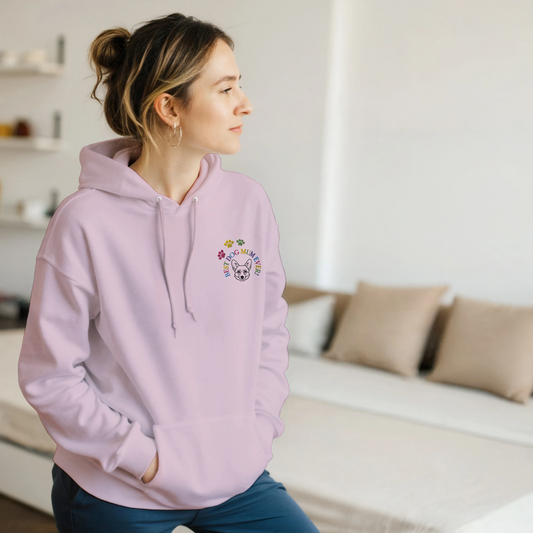 Custom Embroidered Classic Pullover Hoodie | Best Dog Mum Ever! Woman in pink hoodie standing in a bedroom.