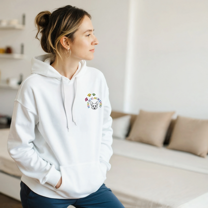 Custom Embroidered Classic Pullover Hoodie | Best Dog Mum Ever! Woman in a white hoodie standing in a bedroom.
