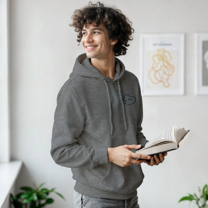 Custom Embroidery, Heart Personalized with Your Pet's Name on a Pullover Grey Hoodie Sweatshirt hearts inside blue thread young man standing in a room holding a book and smiling.