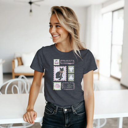 Woman wearing a dark gray Halloween stamps t-shirt and jeans while standing in a bright living area.