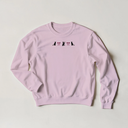 Pink sweatshirt with black cats and pink bows embroidered in a line across the front. The shirt is flat on a light gray background