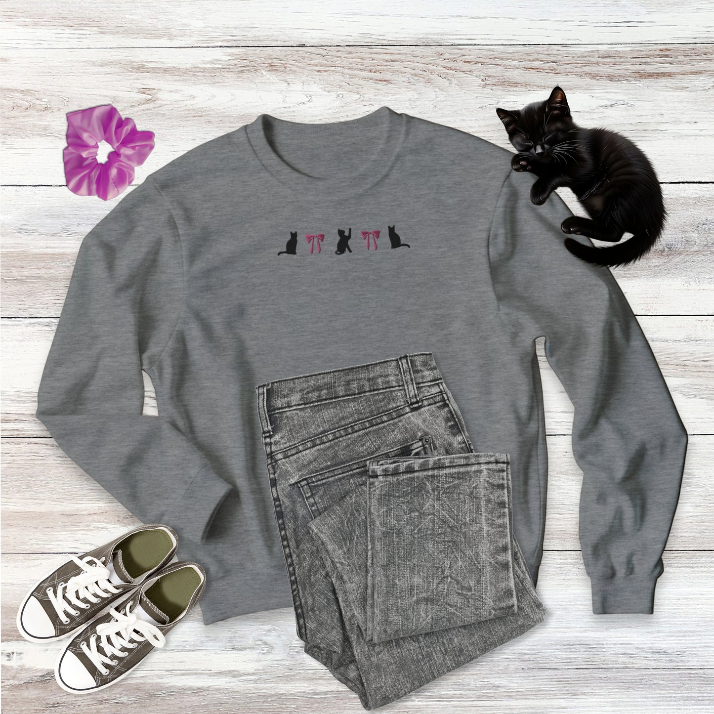 Embroidered Coquette Pink Bows and Black Cats Gildan comfy pullowver crew neck Sweatshirt in sport grey on wooden background with outfit style suggestion and sweet black kitten sleeping.