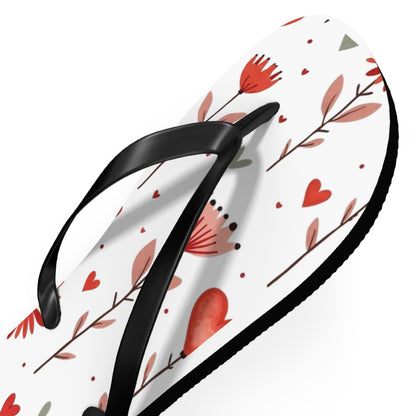 These cushioned Flip Flops have a durable Pink Floral print with hearts. The light weight sandles are shown on a white background. This shows the detail of the black strap of the slip-on sandle.