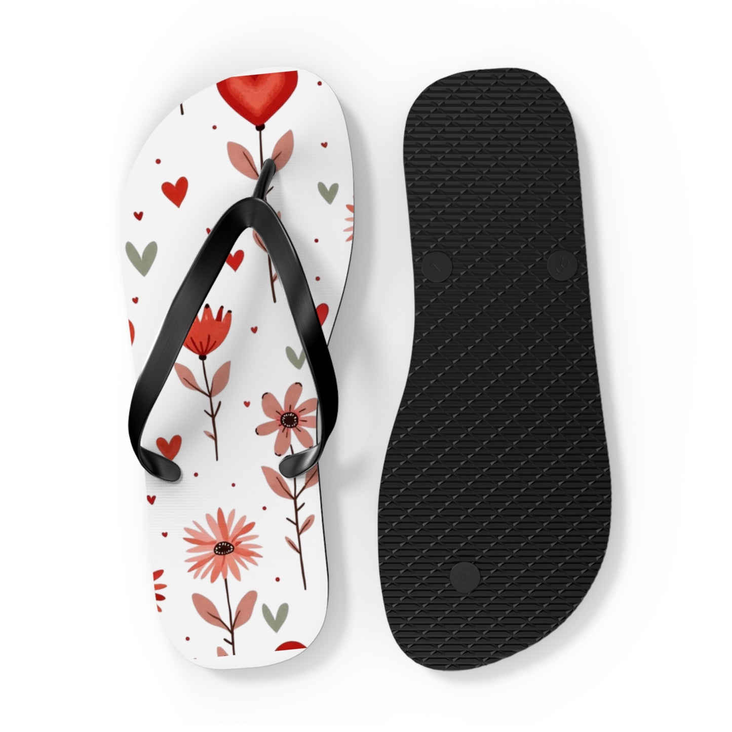 These cushioned Flip Flops have a durable Pink Floral print with hearts. The light weight sandles are shown on a white background. This shows the sole of slip-on sandle. The soles are black.