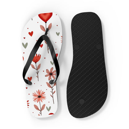 These cushioned Flip Flops have a durable Pink Floral print with hearts. The light weight sandles are shown on a white background. This shows the sole of slip-on sandle. The soles are black.