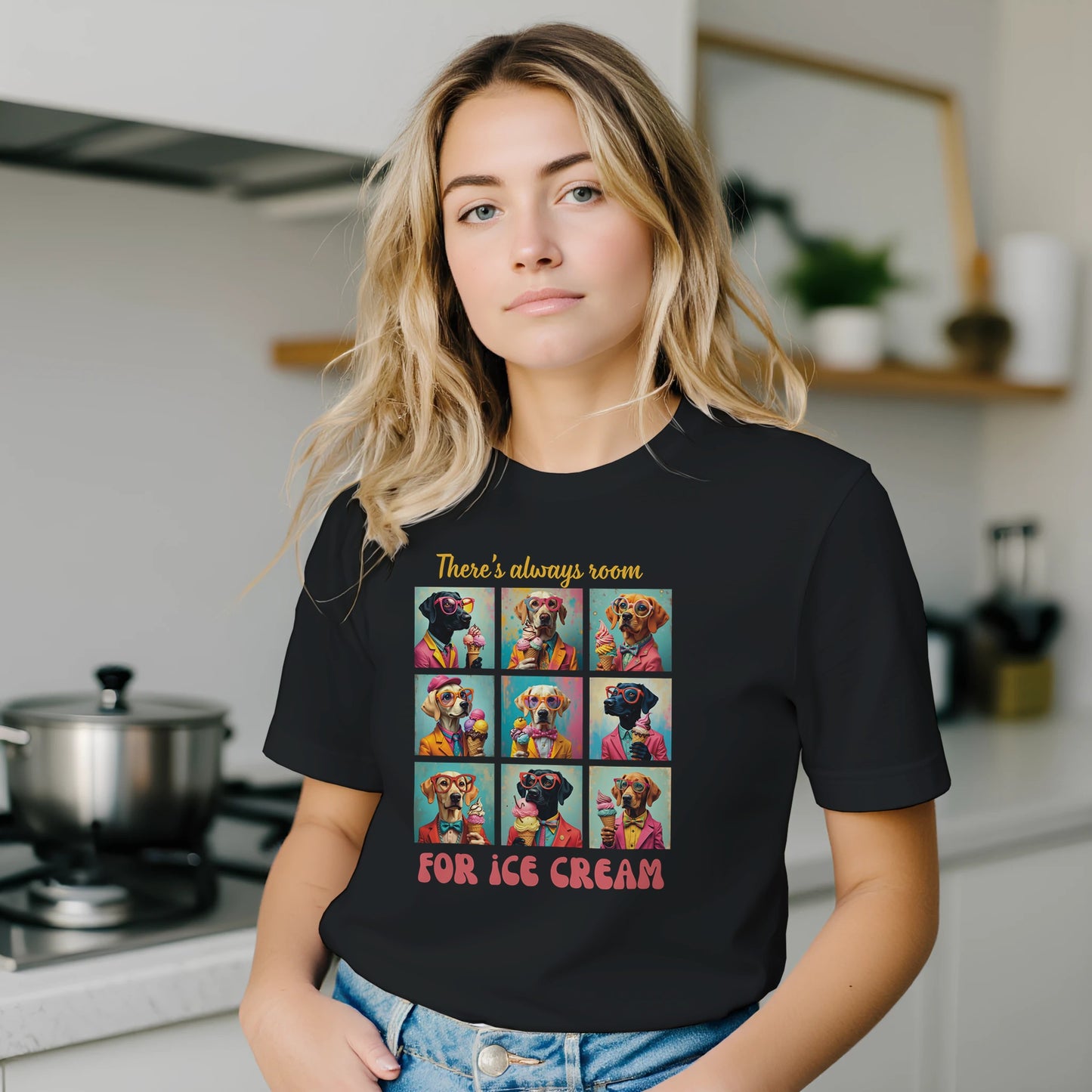 Person wearing a black t-shirt with a colorful graphic and text in a kitchen.