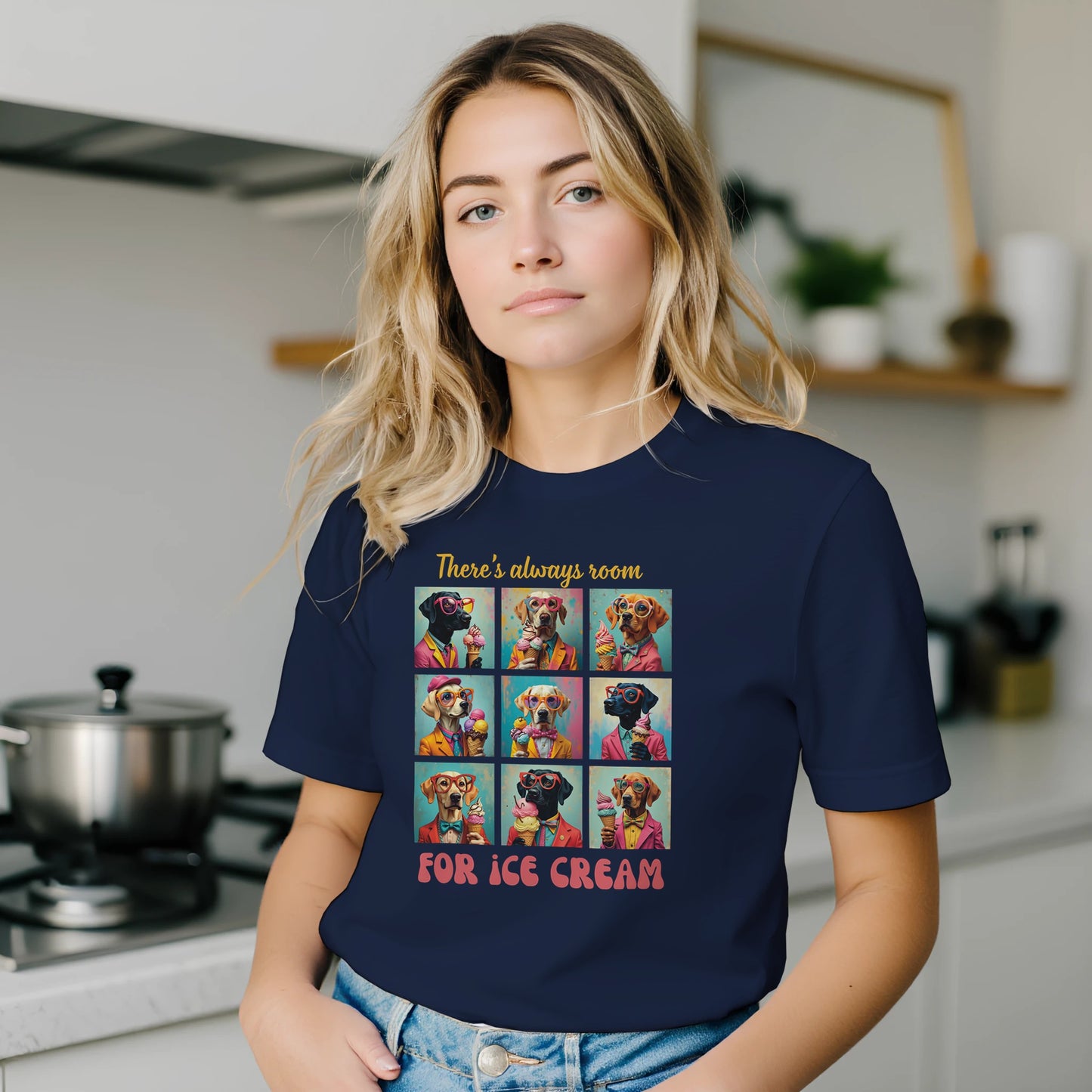 Person wearing a navy blue t-shirt with a colorful graphic and text in a kitchen.