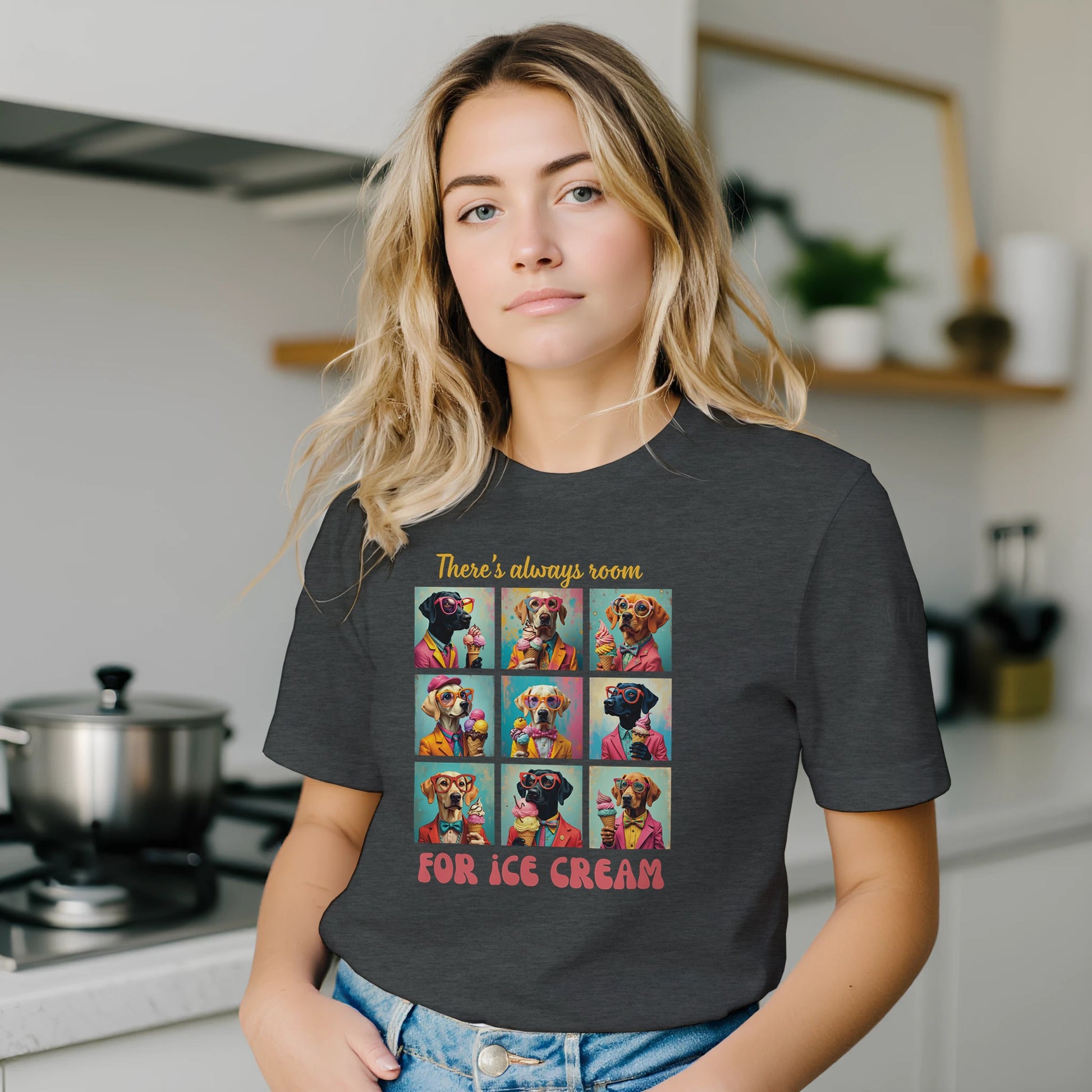Woman wearing a dark gray t-shirt with a colorful graphic and text in a kitchen.