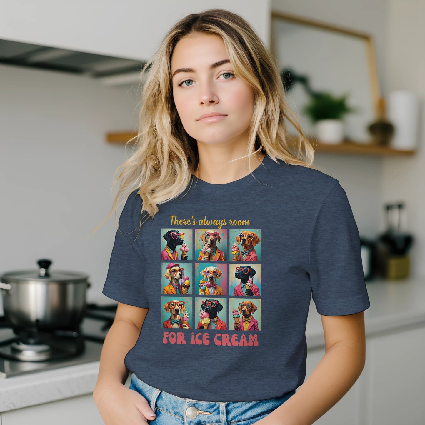 Woman wearing a dark heather blue t-shirt with a colorful graphic and text in a kitchen.