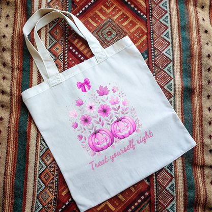 White tote bag with cute pink Halloween design and text on a a woven rug background
