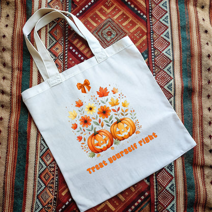 White tote bag with vintage orange Jack 'o Lantern pumpkins and flowers design on a patterned fabric background