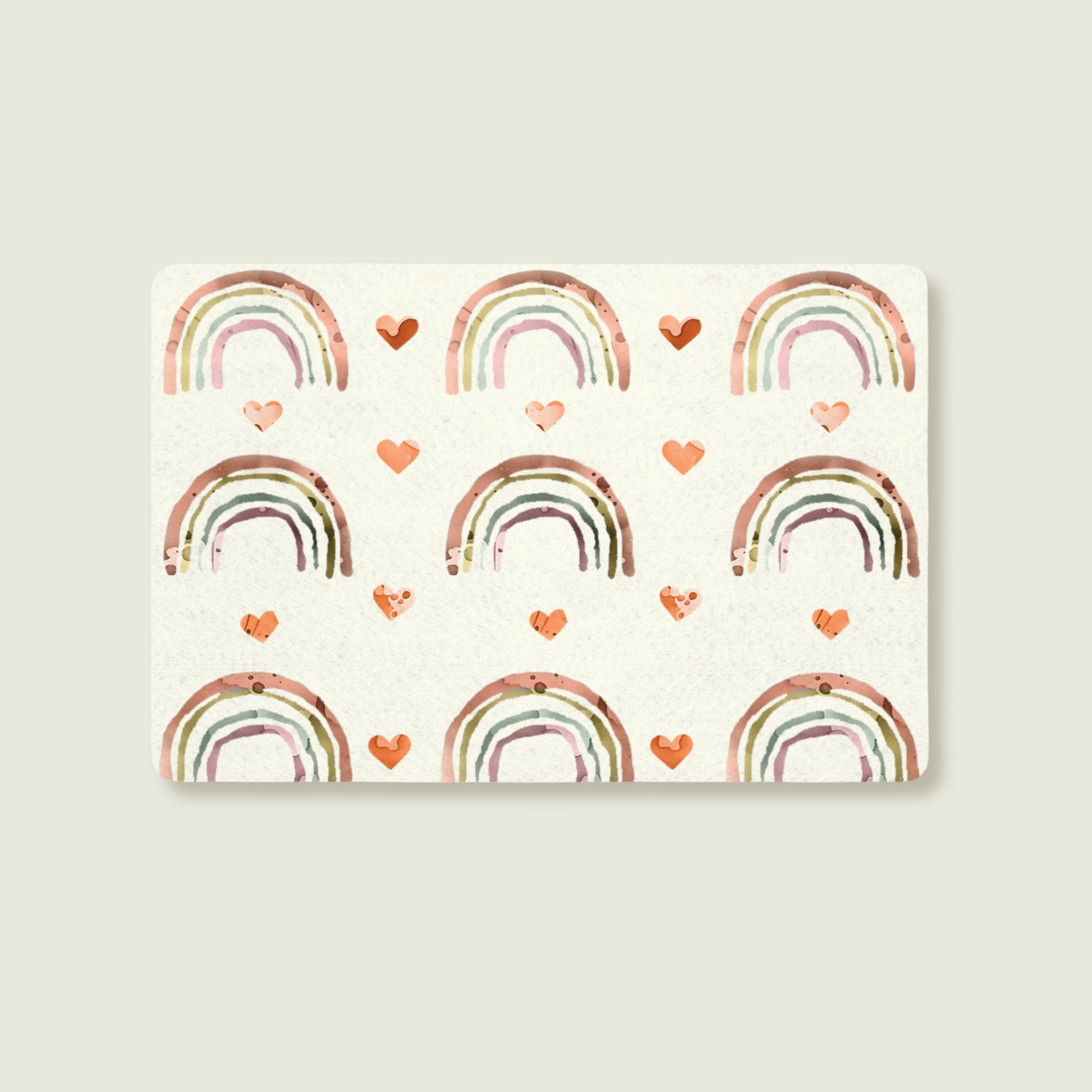 Pet Feeding mat with a watercolour like pattern of rainbows and hearts on a soft white background.