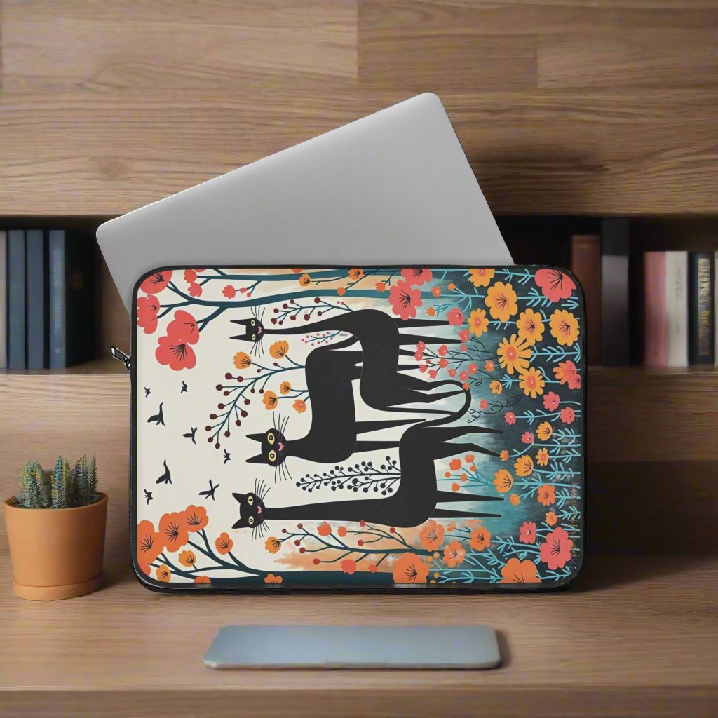 Laptop case with three black cats staanding in spring flowers laptop out