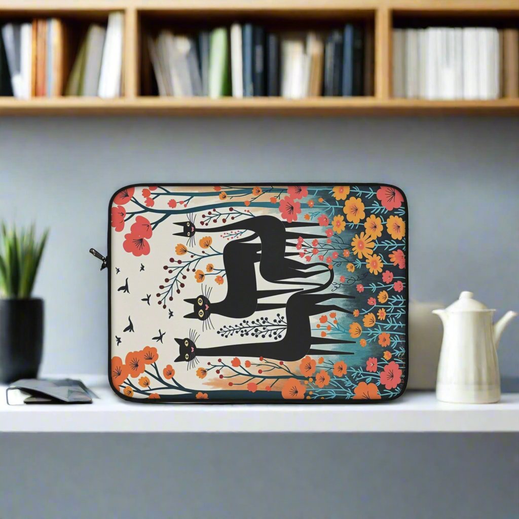 Laptop sleeve with three black cats surrounded by spring flowers context