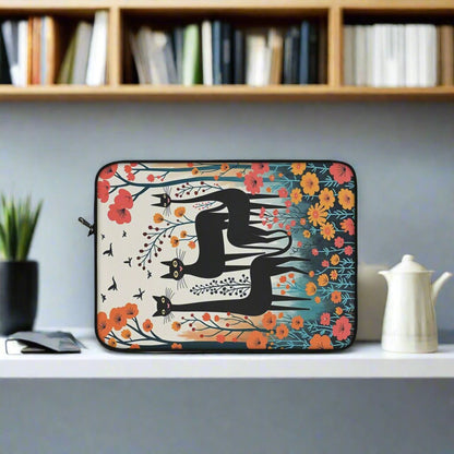 Laptop sleeve with three black cats surrounded by spring flowers context