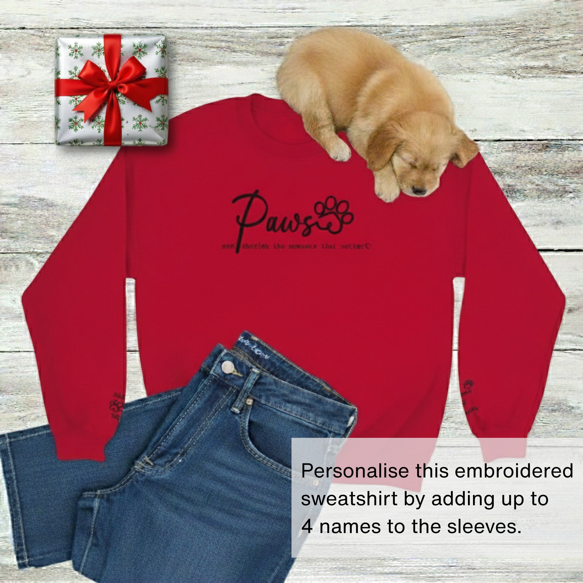 Custom embroidered crew neck pullover sweatshirt in red with blue jeans, a present, and a cute puppy. 'Paws and cherish the moments that matter.'