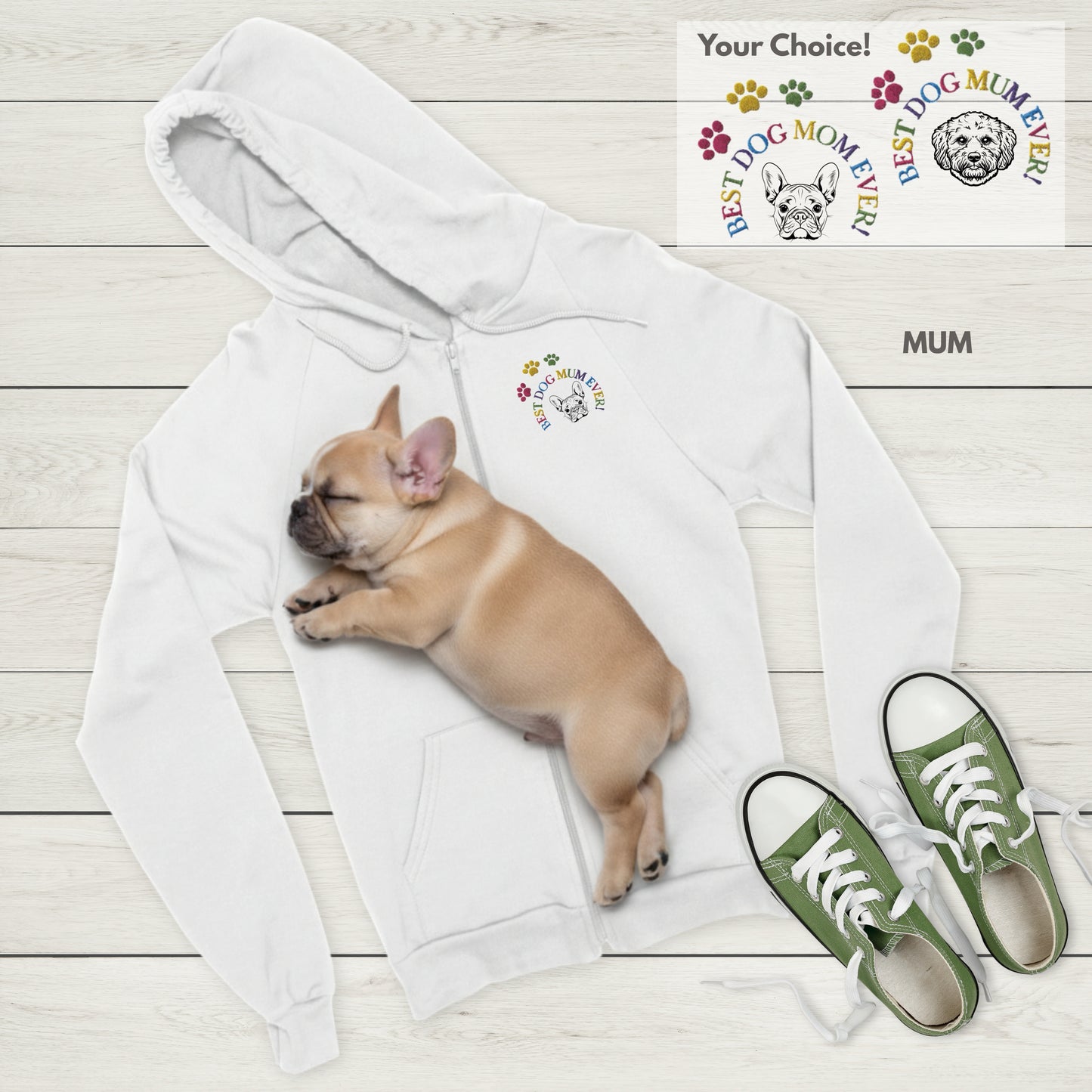 White Zip hoodie with Best Dog Mum Ever! and French Bulldog embroidery, sleeping Frenchie puppy, and green sneakers on a light wooden floor.