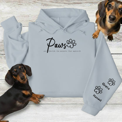 Ash Grey Gildan Hoodie Sweatshirt with Custom Embroidery - up to 4 names on sleeves. Embroidery on the front of this shirt reads, 'Paws and cherish the moments that matter.' Flatlay with 2 Dachshunds