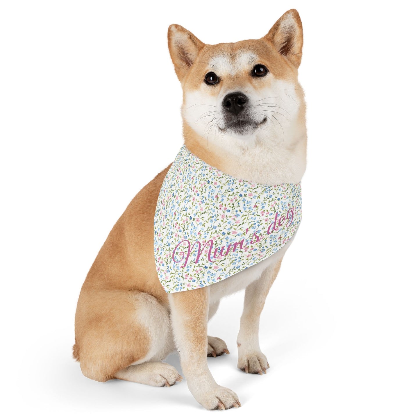 Dog wearing a pink and blue floral bandana with 'Mum's dog' text on a white background