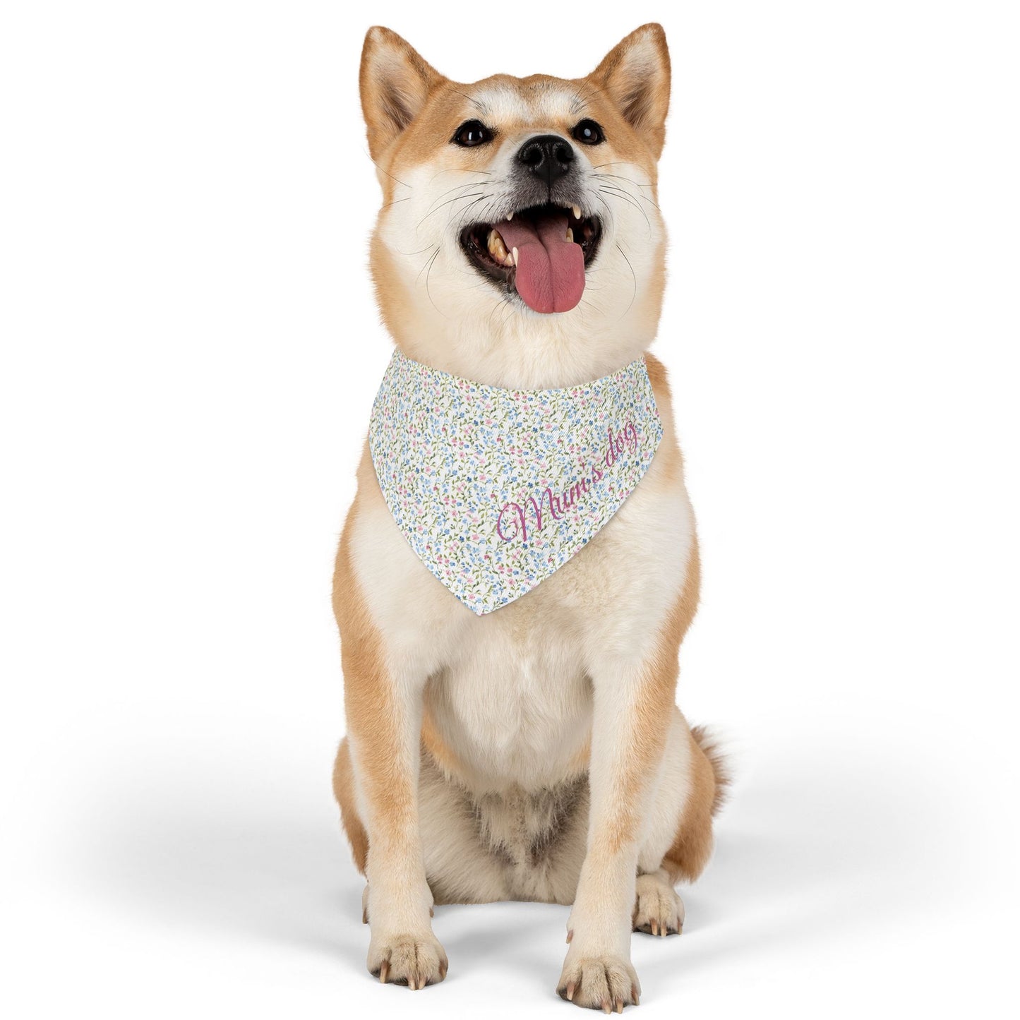 Dog wearing apink and blue floral bandana with text, 'Mum's dog' on a white background