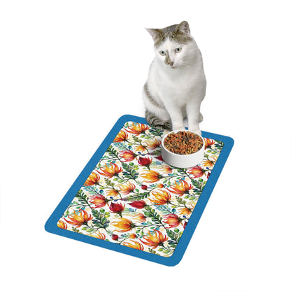 Bright Protea flowers and teal boarder on a mat with a cat sitting on the mat/