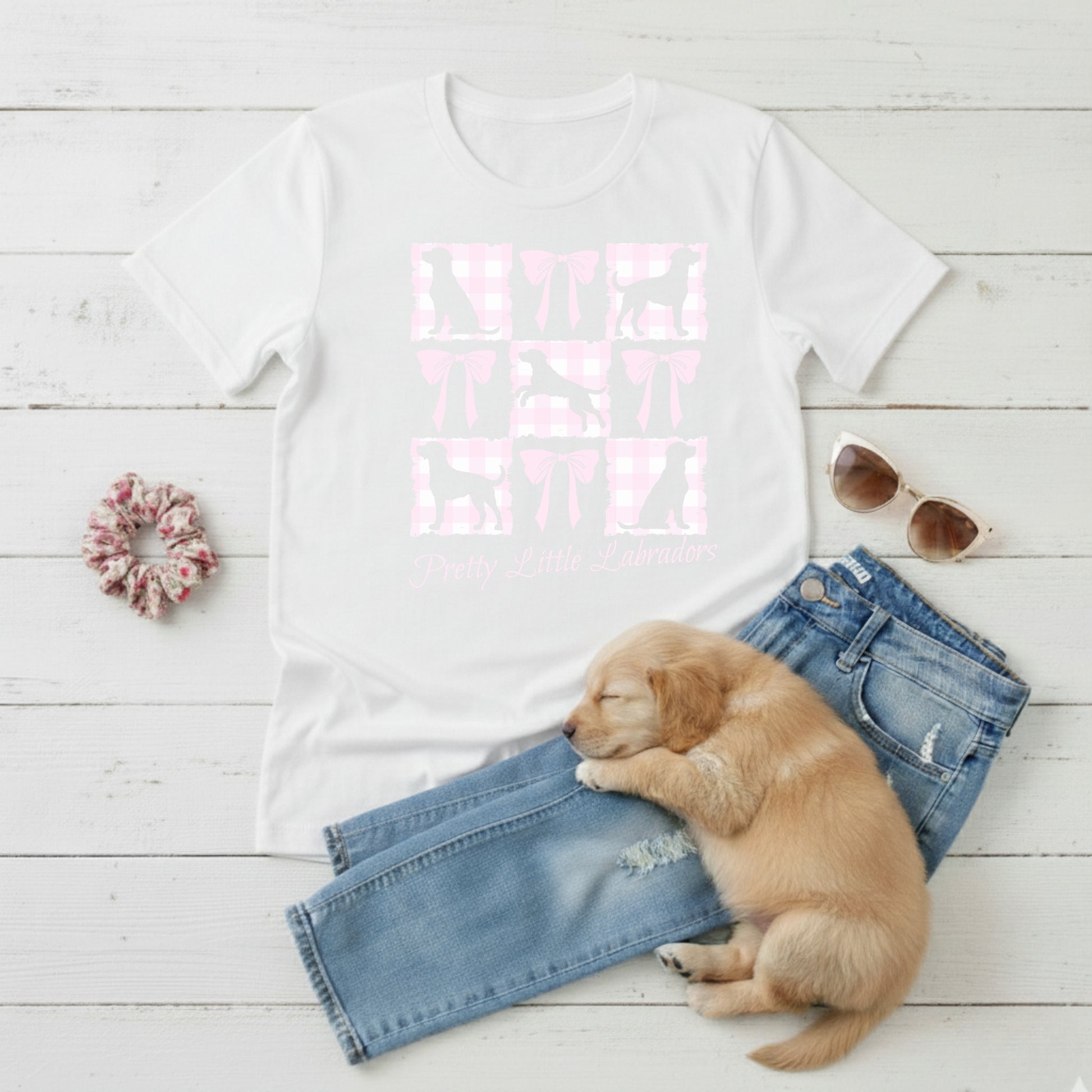  a Bella Canvas 3001 white t-shirt with a Coquette Pink Bows & Checks Labrador Mum design flat lay with wardrobe suggestion and cute puppy.