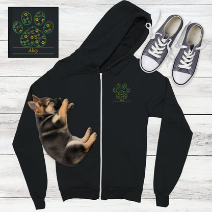 Black zip hoodie with yellow cottagecore flowers embroidered inside a paw print with space for custom pet's name - flat lay with sleeping German Shepard puppy and sneakers