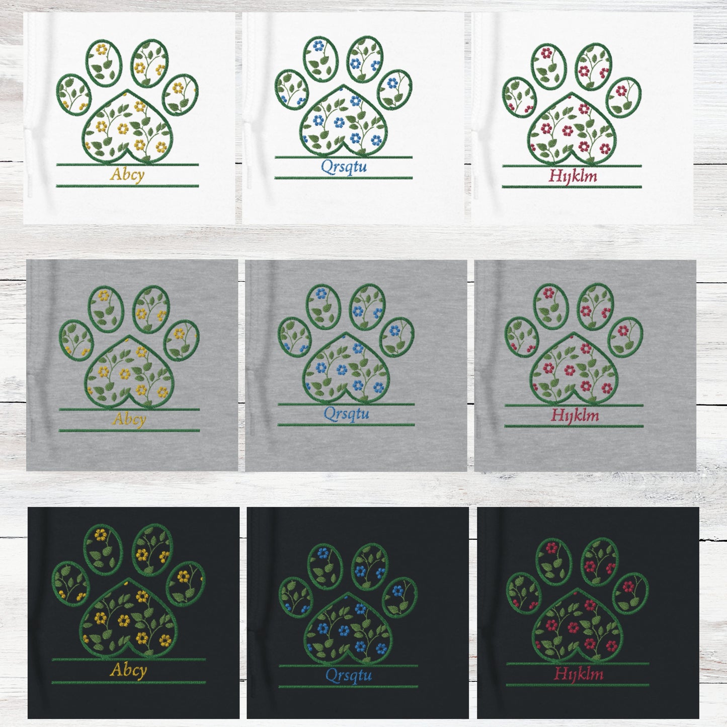 Set of floral paw print designs on white, grey and black sweatshirt backgrounds. Cottagecore retro floral design is shown in yellow, blue, and pink for each sweatshirt colour. The background of the image is a light wooden surface.