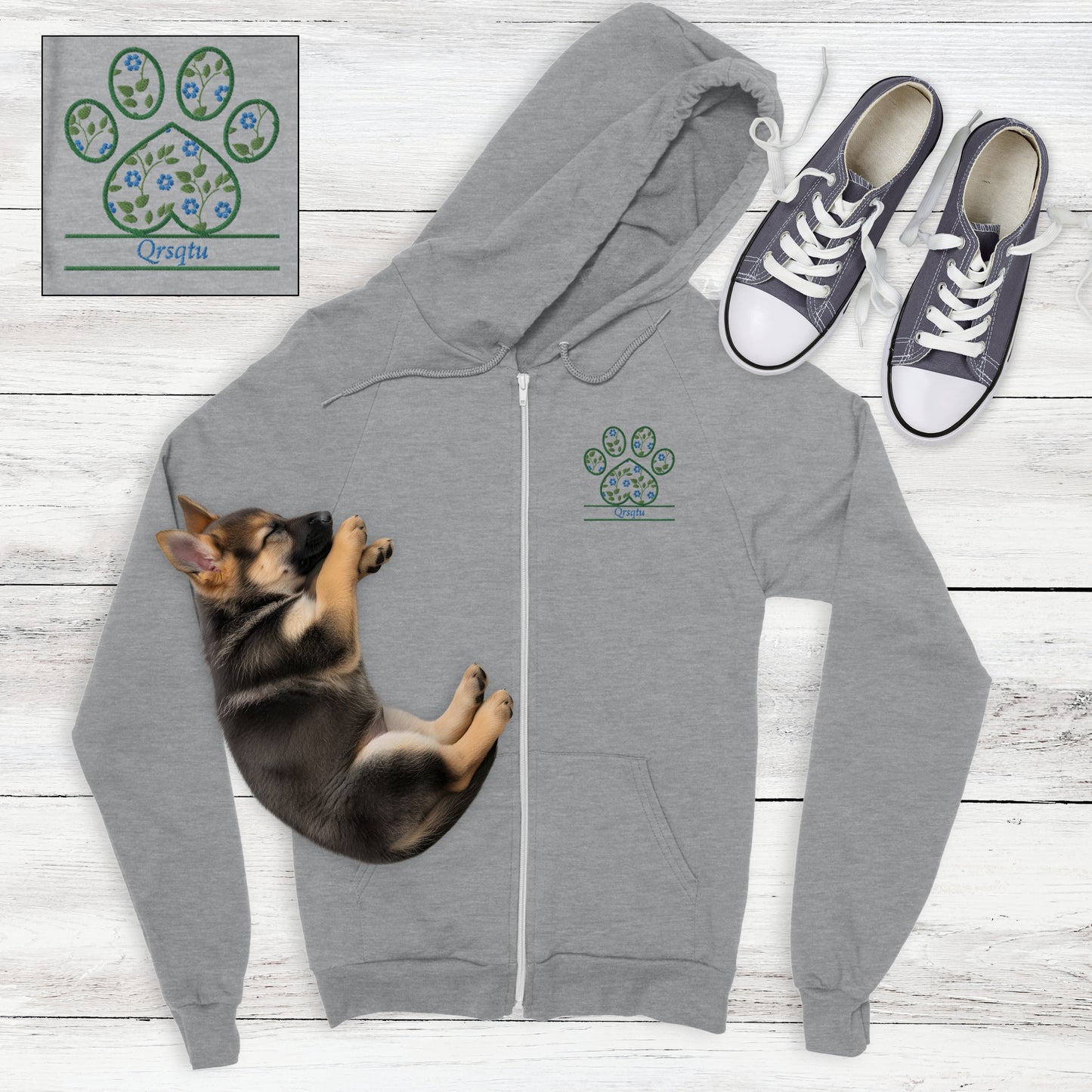 Grey zip hoodie with blue cottagecore flowers embroidered in a paw print with space for custom pet's name - flat lay with sleeping German Shepard puppy and sneakers