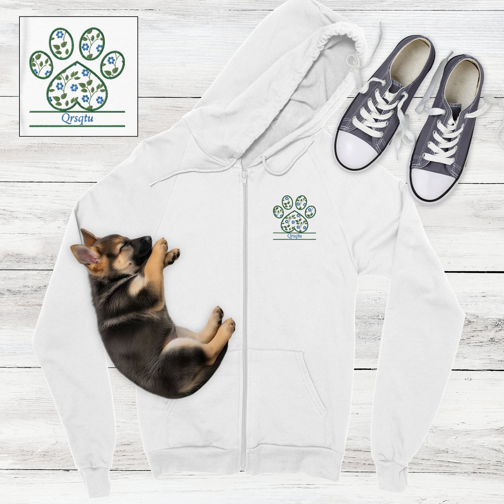 White zip hoodie with blue cottagecore flowers embroidered in a paw print with space for custom pet's name - flat lay with German Shepard and sneakers