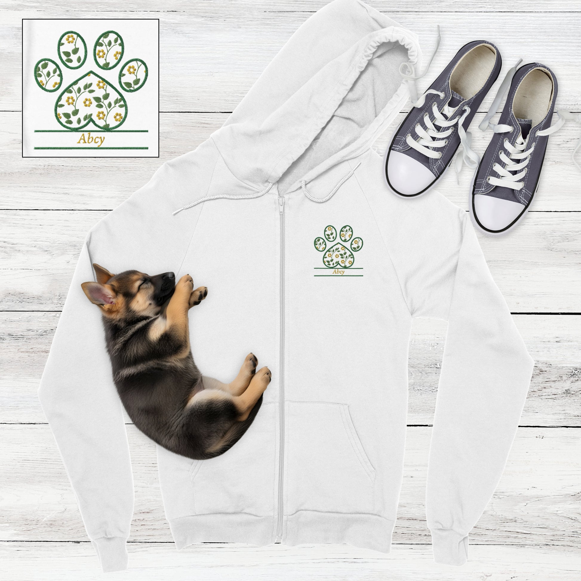 White zip hoodie with yellow vintage  flowers embroidered inside a paw print with space for custom pet's name - flat lay with German Shepard puppy and sneakers