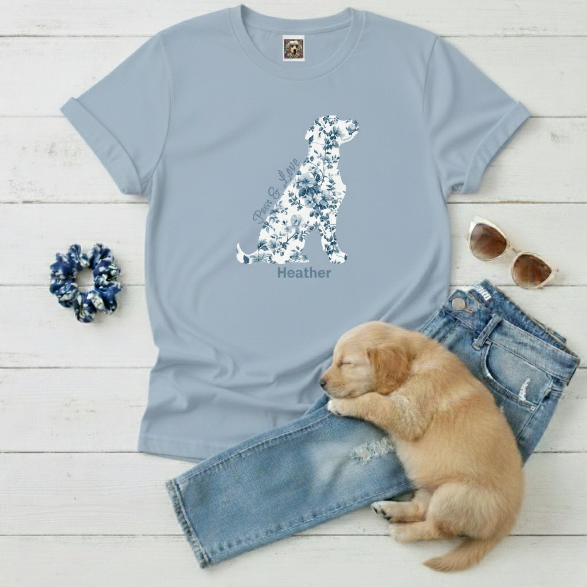 Light blue 100% cotton t-shirt with Blue Toil De Jouy floral dog design, scrunchie, sunglasses, and puppy on a wooden surface