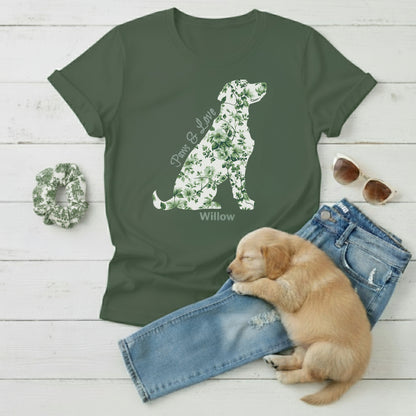 Green Gildan 100% cotton t-shirt with country French floral dog design, sunglasses, scrunchie, aLabrador puppy, and jeans on a wooden surface