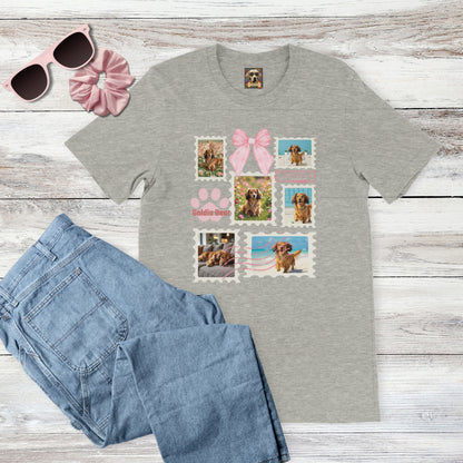 Personalized pet photo gray t-shirt with  design of a postage stamp collage and pink bow next to jeans, pink sunglasses, and hair scrunchie on a wooden surface