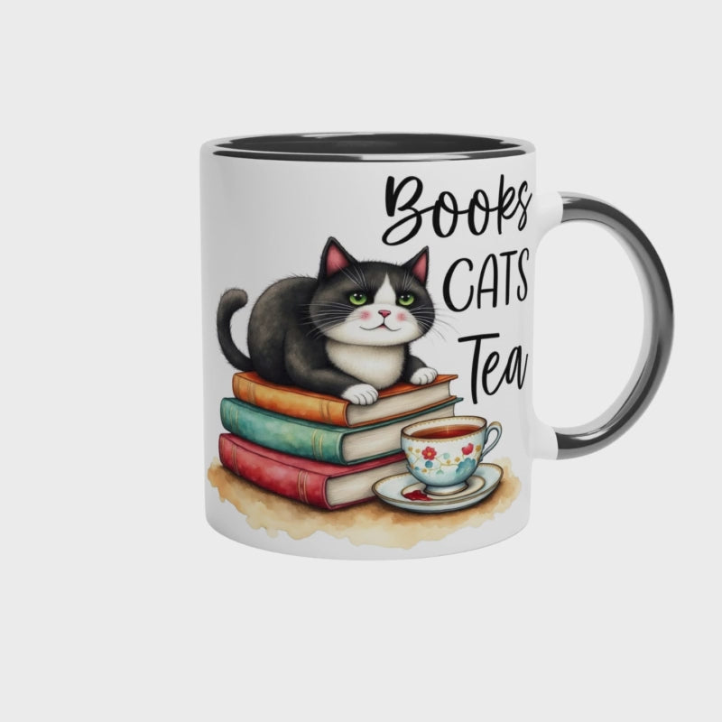 Video of books cats tea mug with black colour inside. The video shows three views of the cute mug perfect for a bookish cat owning tea drinker.