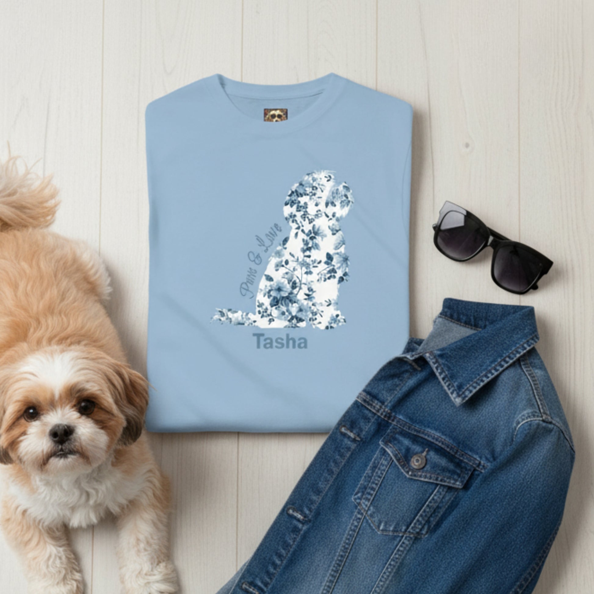 Personalised Light blue t-shirt with Chinoiserie blue flora print in the shape of a Shih Tzu graphic and 'Paws & Love'  text plus dog's name with style suggestions - sunglasses, and denim jacket on a wooden surface plus a Shih Tzu.
