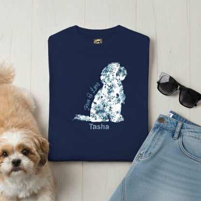Personalised Navy blue t-shirt with floral toile de jouy Shih Tzu design and 'Paws & Love' text, next to a small dog, sunglasses, and jeans on a light wooden surface.