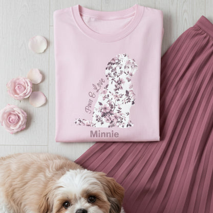 Pink cotton t-shirt with French country floral design in the shape of a Shih Tzu and 'Paws & Love' text, pink pleated skirt, and small dog on a light wooden surface.