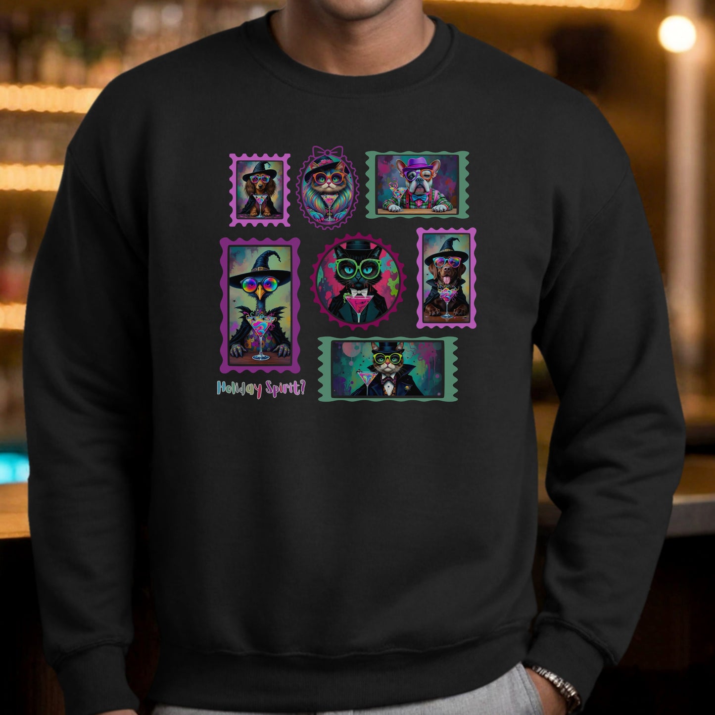 Man wearing a black sweatshirt with colorful graphic design ofwitchy cats,   enchanted dogs and a spooky goose in hats drinking colorful cocktails on a blurred background of a pub.