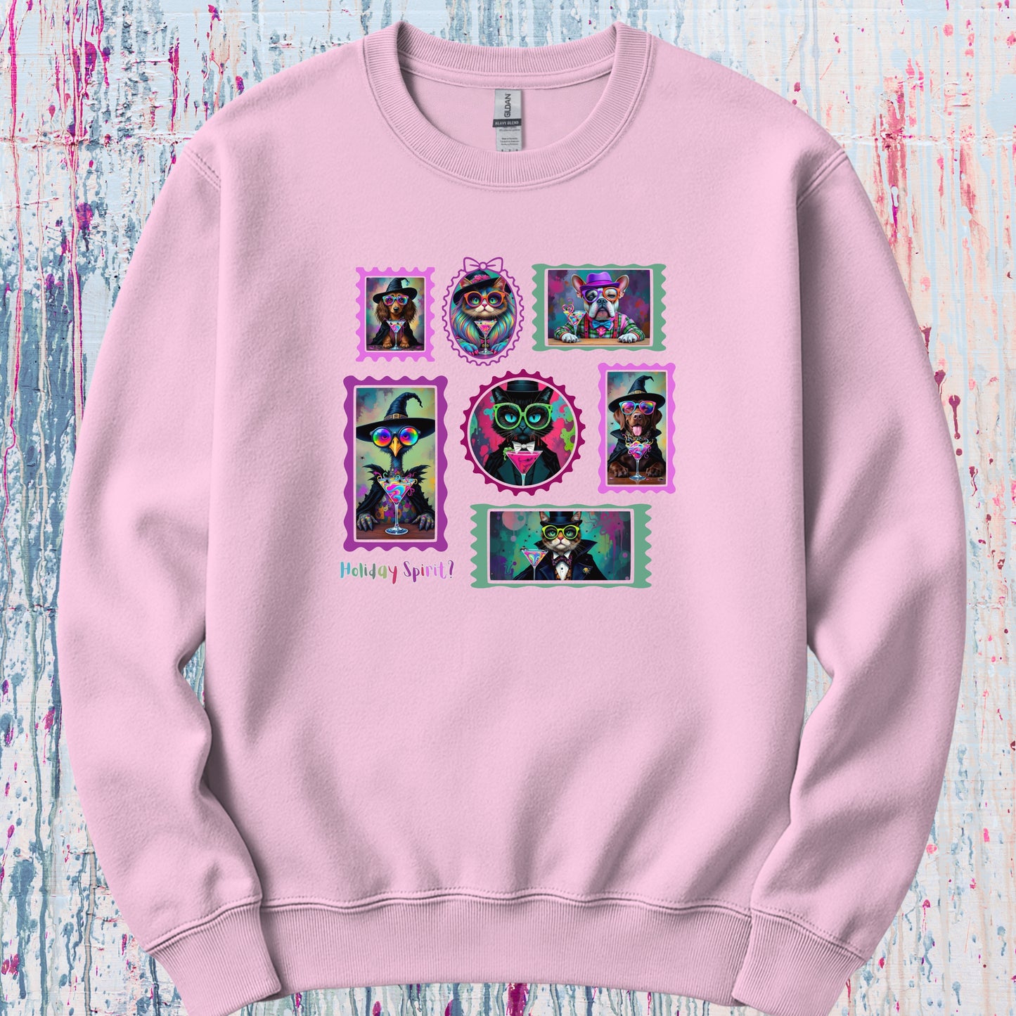 A pink sweatshirt with colorful graphic design of witchy cats,  enchanted dogs and a spooky goose in hats drinking colorful cocktails on a flat background