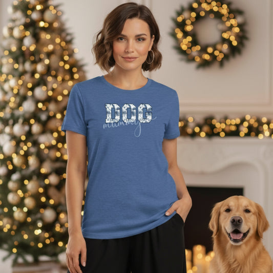 Woman wearing a French Country Floral blue Bella Canvas 3001 t-shirt with 'DOG' text, standing in a festive room with a decorated Christmas tree and wreath.