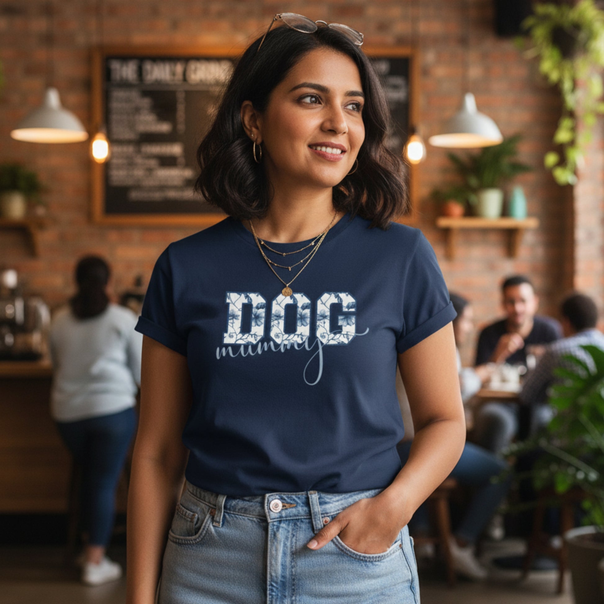 Woman wearing a navy blue t-shirt with 'DOG mom' text in a casual setting
